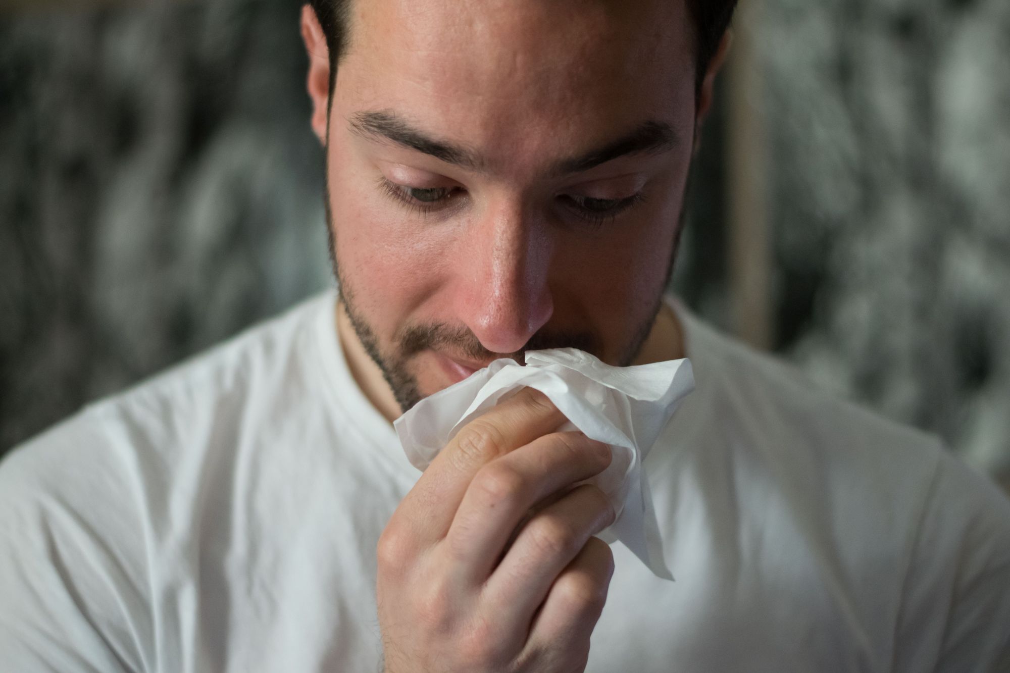 Man with tissues. Allergies can take a toll.
