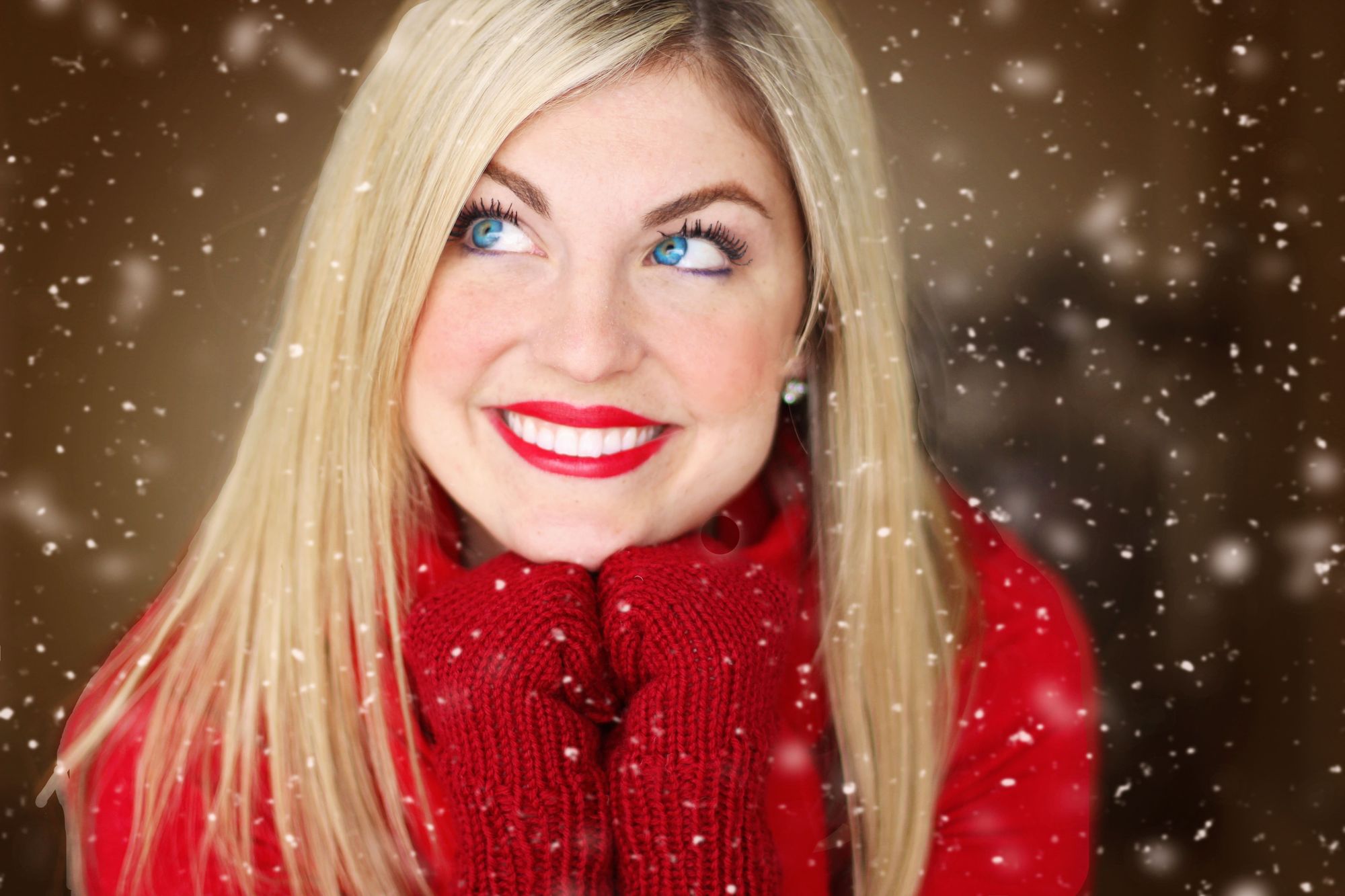 Blonde in red sweater smiling in the snow. Finding The Best Serum For Glowing Skin